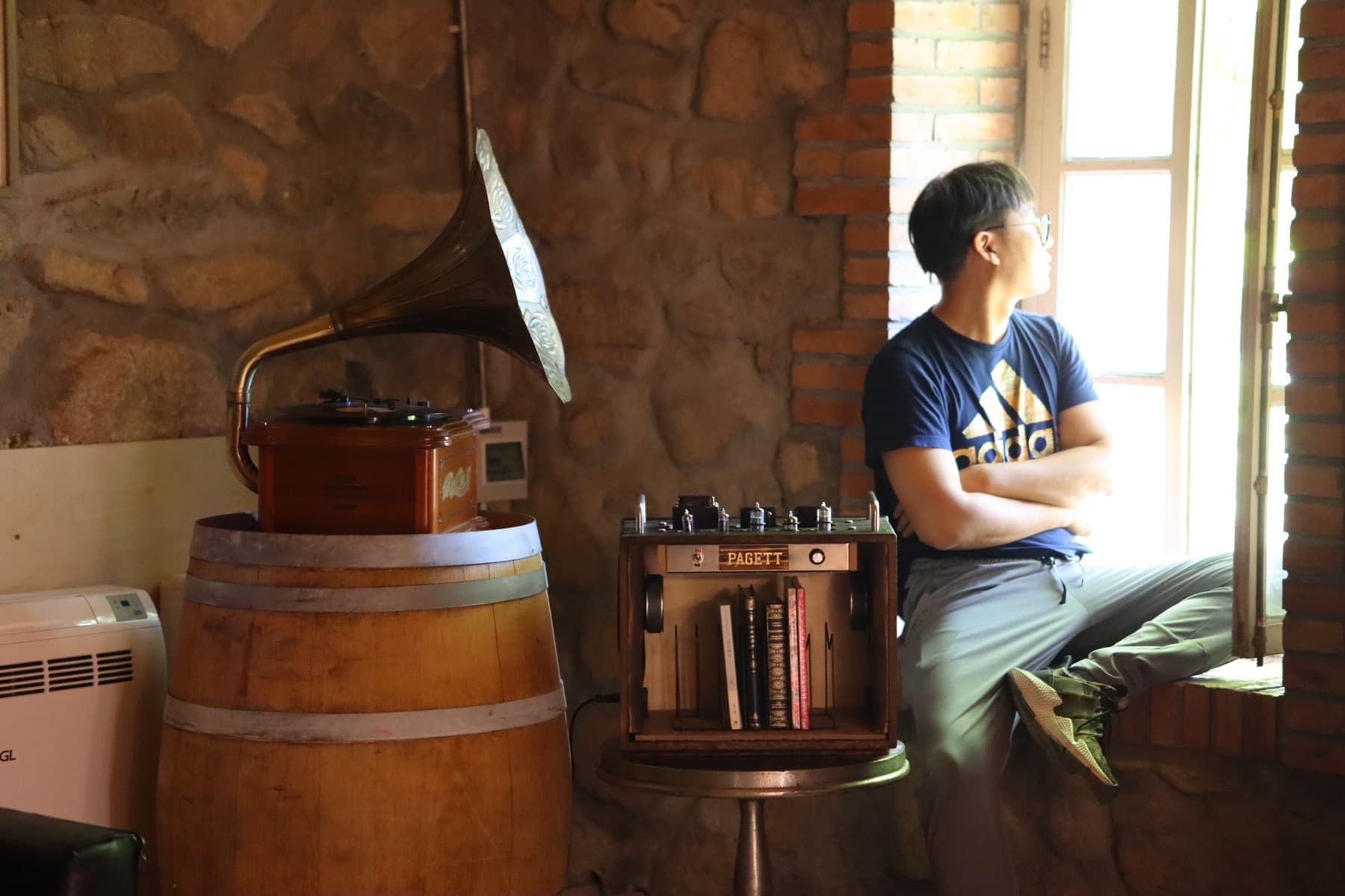 A listener seated beside PAGETT VX-1 in a book-lined room